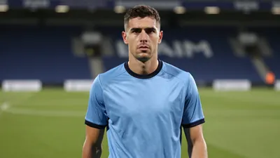Mid-30s anonymous Derby County midfielder, athletic build, waist-up, intense gaze toward camera, wearing a plain sky-blue...