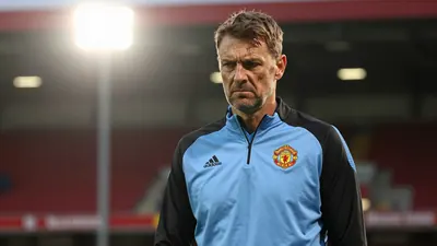 A 35-year-old, ruggedly built Derby County coach, in a plain sky blue and black training top, stands pitchside, eyes...