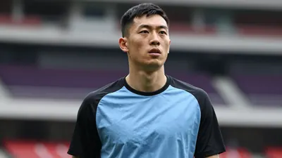 Mid-20s forward, athletic build, waist-up, face sharp and expressive, wearing a plain sky-blue shirt with black sleeves...